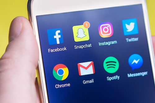 Social media apps on mobile phone screen